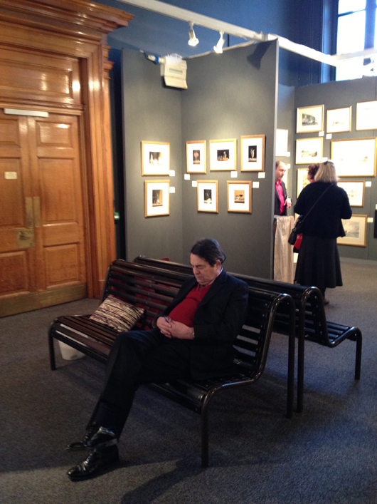 A visitor to the Watercolour and Works on Paper Fair at the Science Museum in London grabs some well-earned shut-eye. Image Auction Central News.